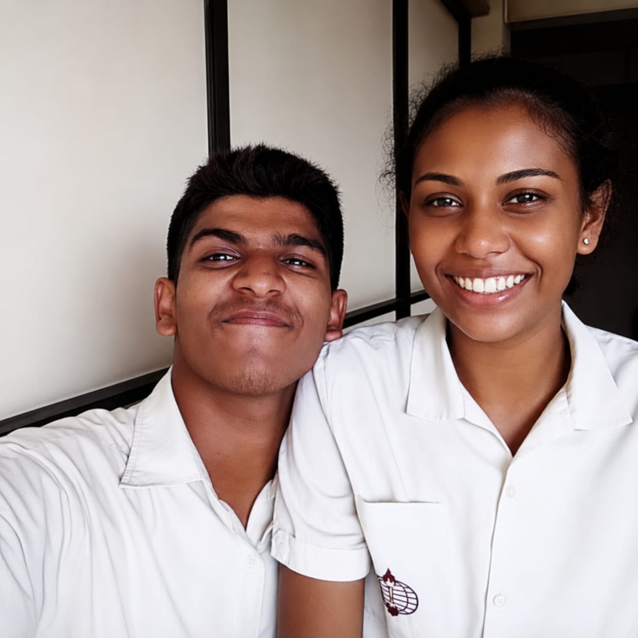Amanda and Ashwinth as teenagers in their school uniforms